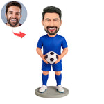 Figura cabezona personalizada de portero sosteniendo un balón de fútbol.